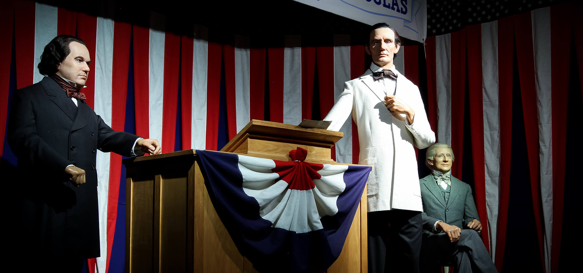 Abraham Lincoln debating against Stephen Douglas on the campaign trail for the Illinois Senate race.